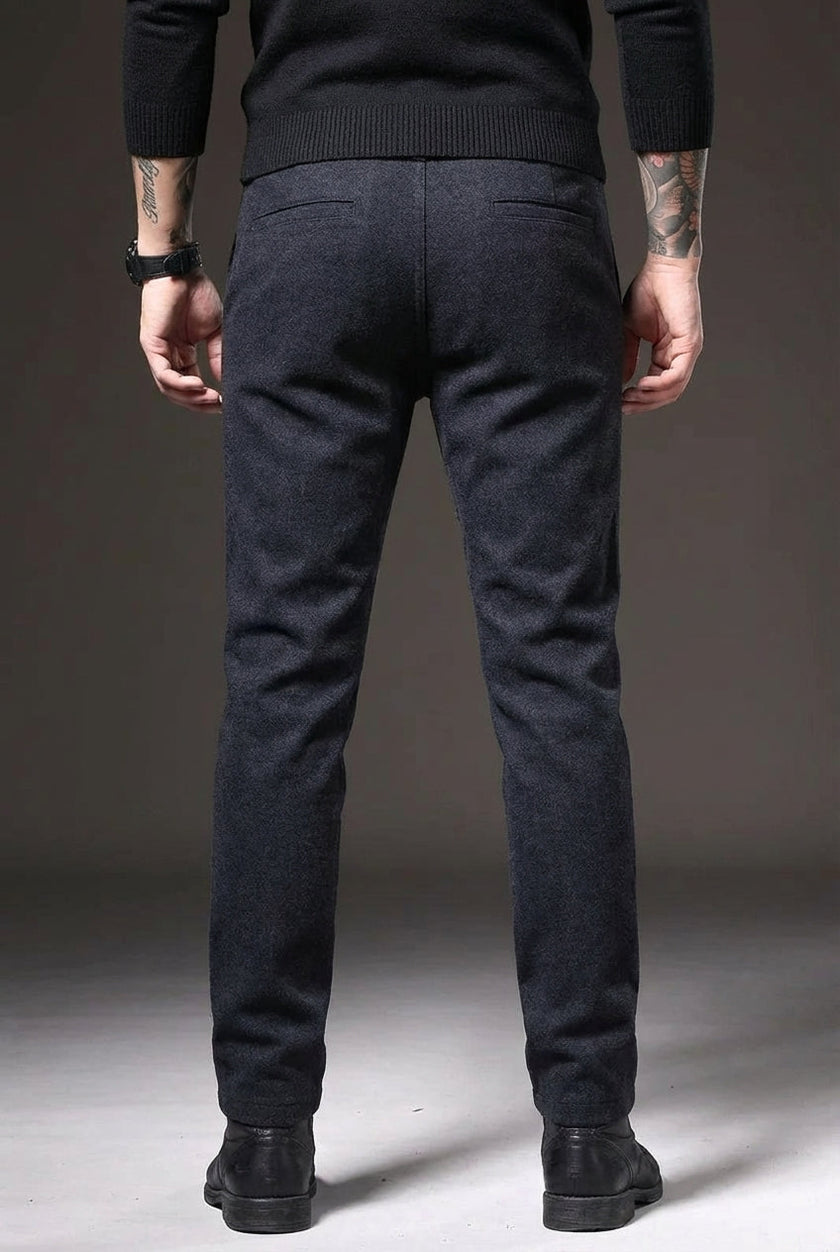 Men's slim-fit blue trousers by FJØRNA, tailored fit with modern style, shown on a male model in a casual setting