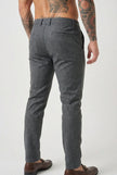 Men's slim-fit trousers in light grey from FJØRNA, showcasing a tailored design and comfortable fit in a close-up image.