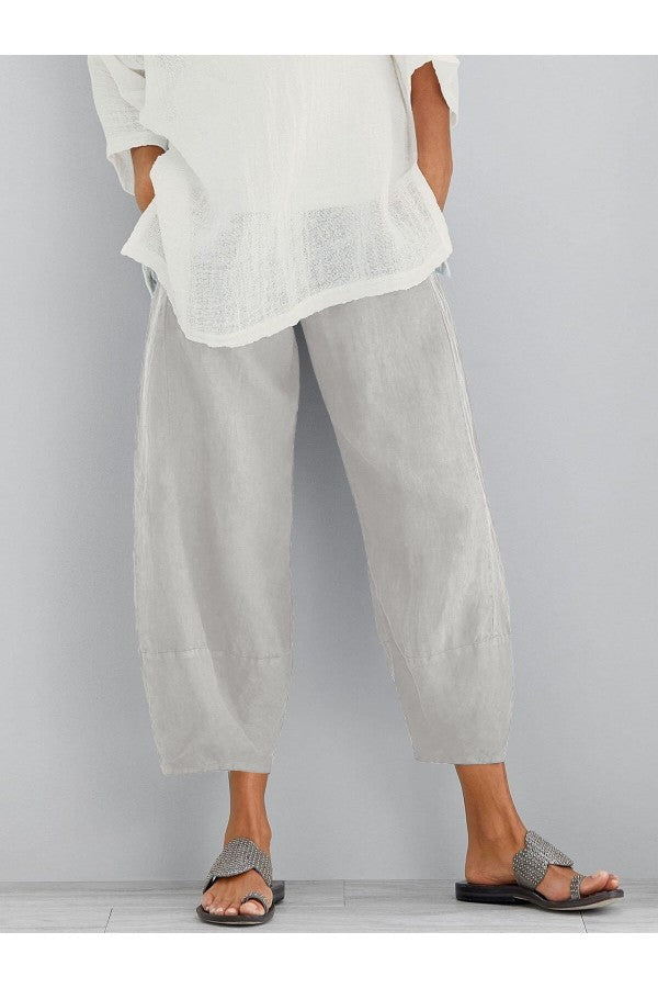 FJØRNA women's lightweight summer trousers with tapered fit, elastic waist, and cropped length, shown in a loose-fit style.