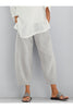 FJØRNA women's lightweight summer trousers with tapered fit, elastic waist, and cropped length, shown in a loose-fit style.