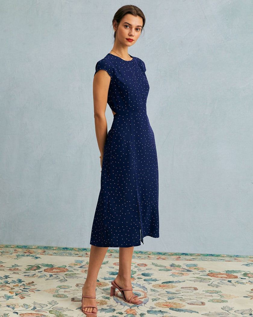 FJØRNA polka dot cutout cap-sleeve midi dress with round neckline, perfect for summer business occasions, shown on a model.
