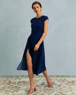 FJØRNA polka dot cutout cap-sleeve midi dress with round neckline, perfect for summer business attire, shown on model.