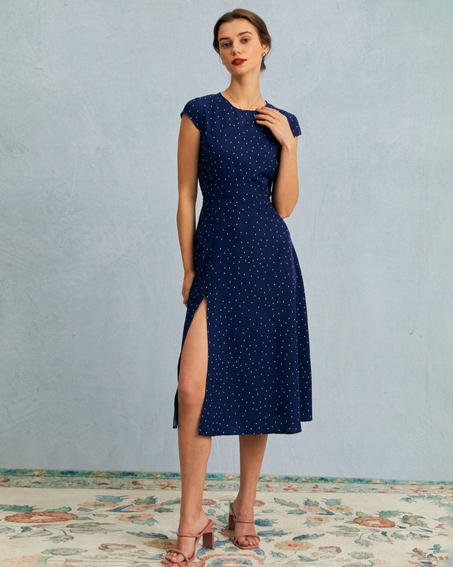 Navy polka dot cutout cap-sleeve midi dress by FJØRNA, featuring a round neckline and stylish summer business dress design.
