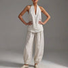White FJØRNA women's two-piece co-ord set with V-neck top and matching pants, featuring front pockets, perfect for summer wear.
