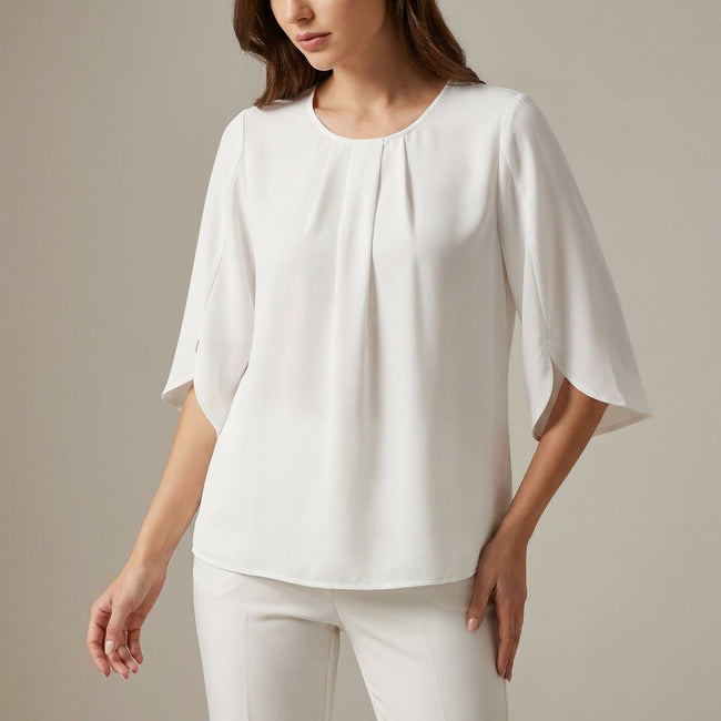White pleated summer blouse for women by FJØRNA, casual top with a relaxed fit and lightweight fabric.