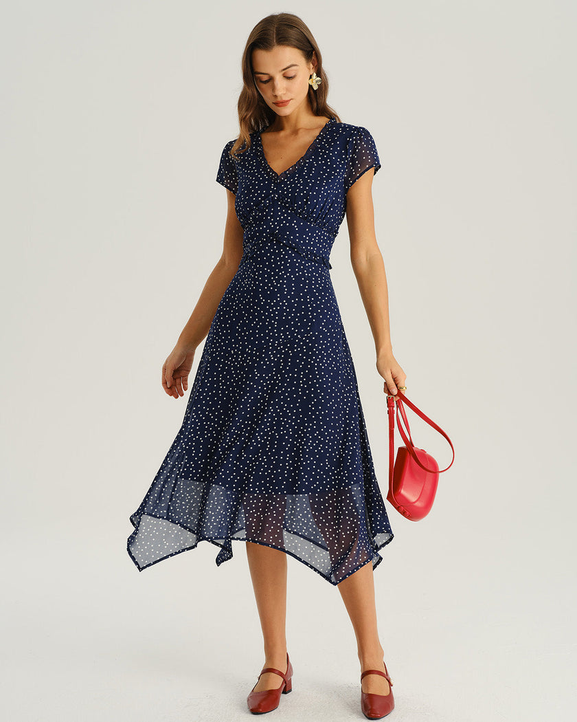 Navy polka dot chiffon V-neck midi dress by FJØRNA, perfect for wedding guests, featuring a flowing woven polyester fabric.
