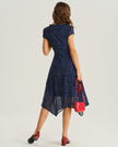 Navy polka dot chiffon V-neck midi dress by FJØRNA, featuring a flowing design perfect for wedding guests.